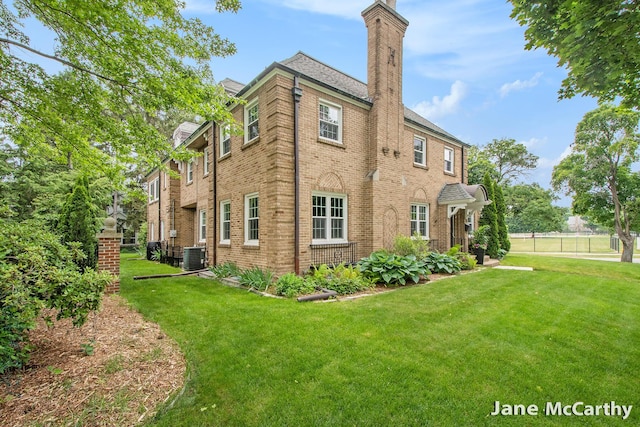 1101 Cadillac Dr SE, Grand Rapids, MI 49506 - rear view of property with a chimney and brick siding
