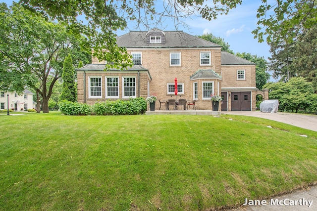 1101 Cadillac Dr SE, Grand Rapids, MI 49506 - back of house featuring brick siding, a yard, and driveway