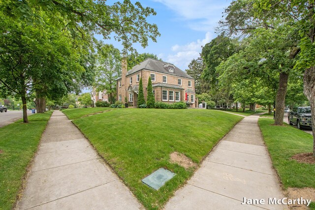 1101 Cadillac Dr SE, Grand Rapids, MI 49506 - view of front facade featuring a front lawn and a chimney