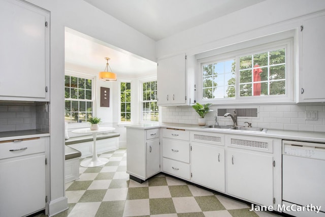 1101 Cadillac Dr SE, Grand Rapids, MI 49506 - kitchen featuring white dishwasher, light floors, healthy amount of natural light, and white cabinets