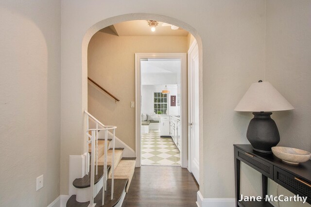 1101 Cadillac Dr SE, Grand Rapids, MI 49506 - corridor with arched walkways, stairway, and dark flooring