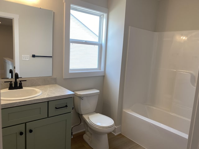 3353 Kings River St SW Unit 34, Wyoming, MI 49418 - full bathroom with vanity, washtub / shower combination, and wood finished floors