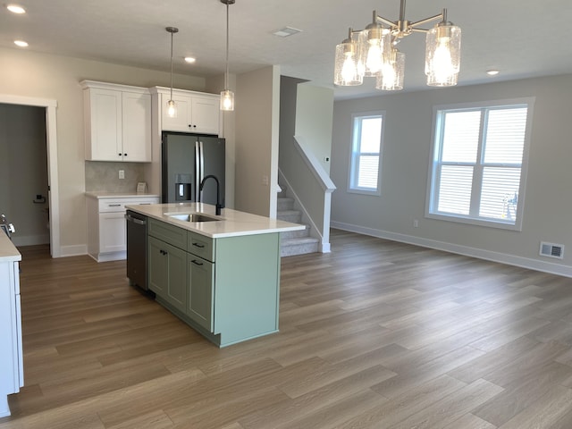 3353 Kings River St SW Unit 34, Wyoming, MI 49418 - kitchen featuring stainless steel appliances, light countertops, light wood-type flooring, recessed lighting, and white cabinets