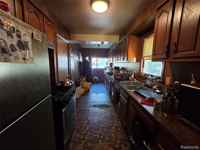 20200 Greeley St, Detroit, MI 48203 - kitchen with freestanding refrigerator, gas range, healthy amount of natural light, and dark countertops