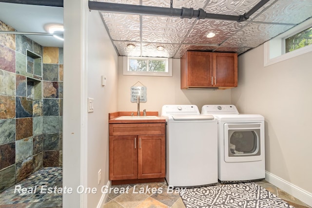 34 E Hannum Blvd, Saginaw, MI 48602 - laundry area featuring washer and dryer and cabinet space