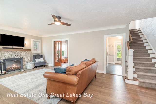 34 E Hannum Blvd, Saginaw, MI 48602 - living area featuring ceiling fan, stairs, wood finished floors, plenty of natural light, and a textured ceiling
