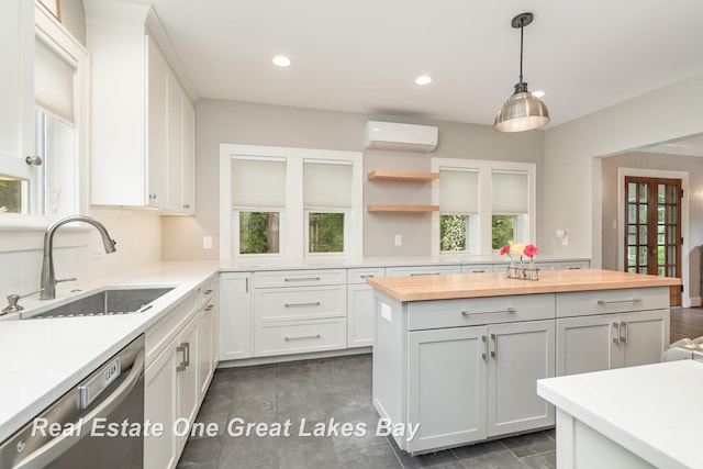 34 E Hannum Blvd, Saginaw, MI 48602 - kitchen with butcher block counters, a wall mounted air conditioner, dishwasher, open shelves, and white cabinetry