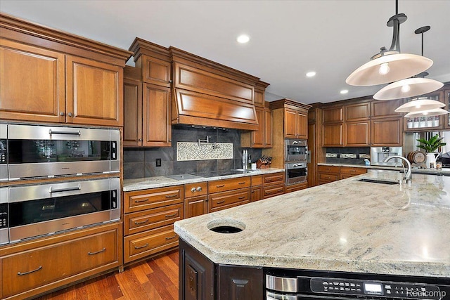 1330 Oxford Rd, Bloomfield Hills, MI 48304 - kitchen with brown cabinetry, tasteful backsplash, light stone counters, and recessed lighting