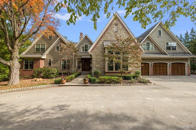 1330 Oxford Rd, Bloomfield Hills, MI 48304 - view of front facade featuring an attached garage, asphalt driveway, and stone siding