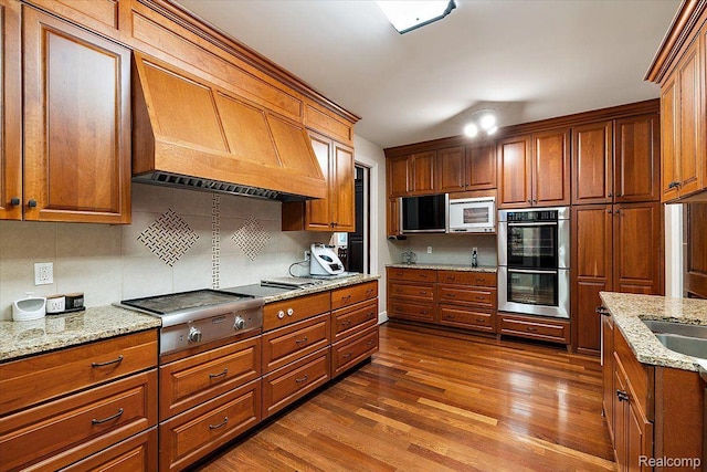 1330 Oxford Rd, Bloomfield Hills, MI 48304 - kitchen with stainless steel appliances, dark wood finished floors, and brown cabinetry