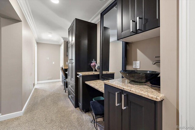 1330 Oxford Rd, Bloomfield Hills, MI 48304 - kitchen with crown molding, light colored carpet, light stone countertops, dark cabinets, and recessed lighting