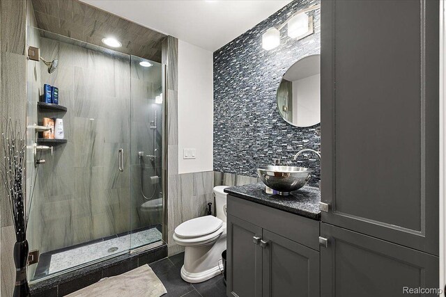 1330 Oxford Rd, Bloomfield Hills, MI 48304 - bathroom with tile walls, a stall shower, vanity, and tile patterned floors