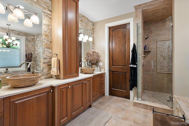 1330 Oxford Rd, Bloomfield Hills, MI 48304 - bathroom featuring a chandelier, double vanity, and a shower stall