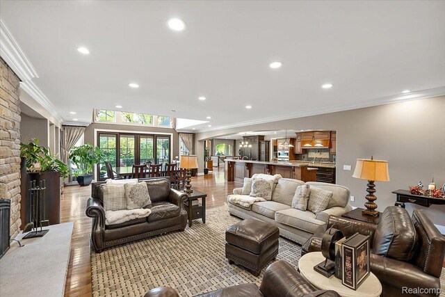 1330 Oxford Rd, Bloomfield Hills, MI 48304 - living area featuring recessed lighting, ornamental molding, and light wood-type flooring