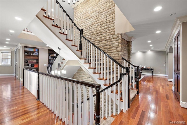 1330 Oxford Rd, Bloomfield Hills, MI 48304 - stairs with wood finished floors, crown molding, recessed lighting, arched walkways, and a chandelier
