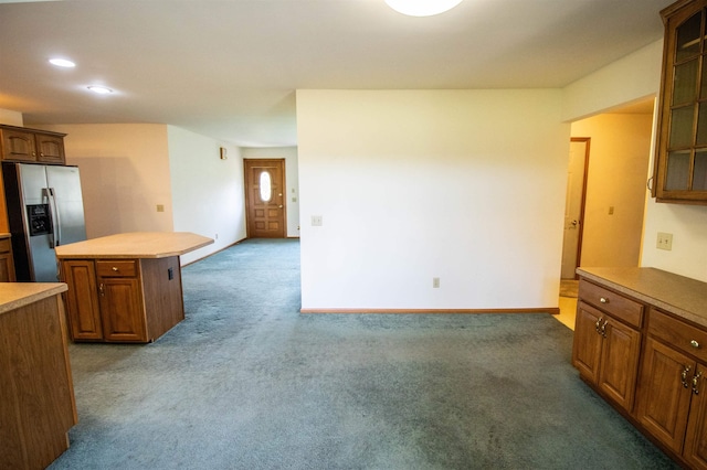 13123 N Jennings Rd, Clio, MI 48420 - kitchen with stainless steel refrigerator with ice dispenser, a kitchen island, carpet, glass insert cabinets, and recessed lighting