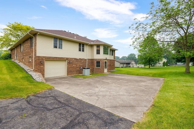 9128 Clover Dr, Milan, MI 48160 - view of side of property featuring brick siding, concrete driveway, a yard, and an attached garage