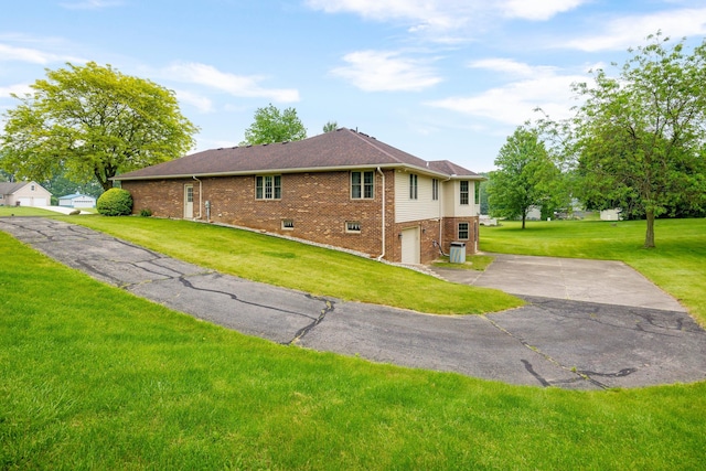 9128 Clover Dr, Milan, MI 48160 - view of property exterior with brick siding, a garage, a yard, and driveway