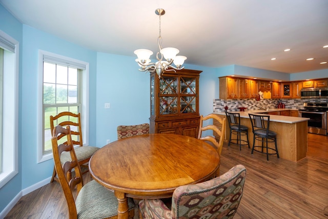 9128 Clover Dr, Milan, MI 48160 - dining space featuring a chandelier, dark wood-type flooring, and recessed lighting