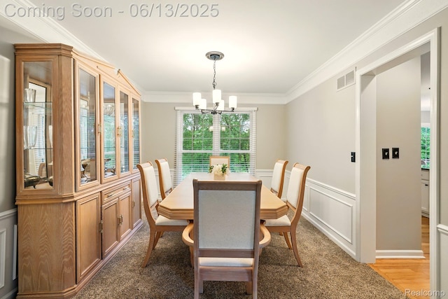 1377 Lake Shore Blvd, Lake Orion, MI 48362 - dining room with a chandelier, plenty of natural light, ornamental molding, wainscoting, and light colored carpet