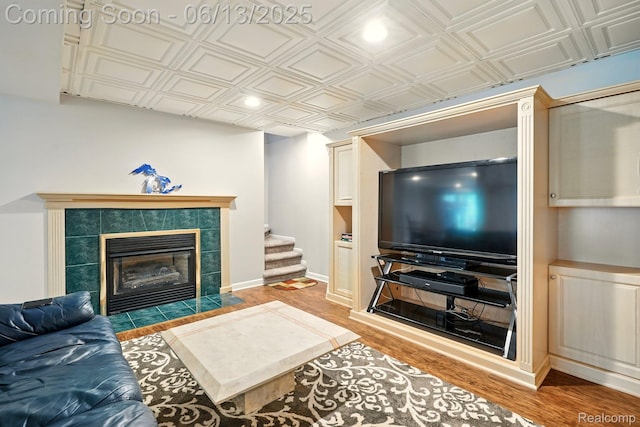 1377 Lake Shore Blvd, Lake Orion, MI 48362 - living room with an ornate ceiling, wood finished floors, a tiled fireplace, recessed lighting, and stairway