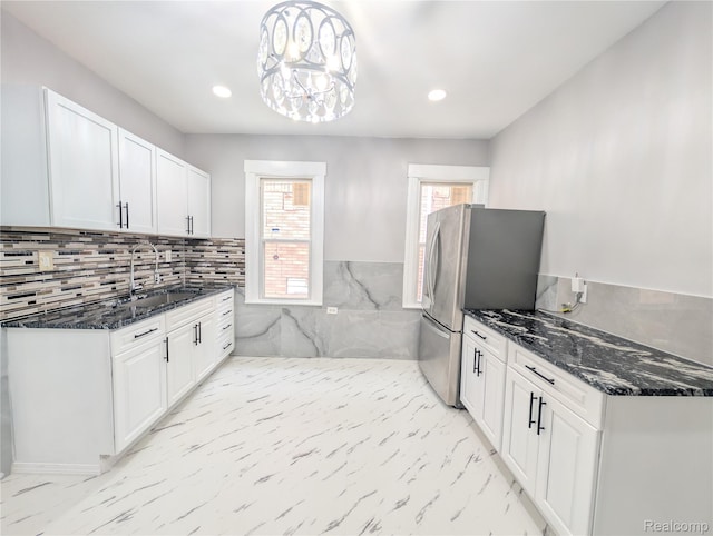 3639 Farnsworth St, Detroit, MI 48211 - kitchen with freestanding refrigerator, white cabinetry, recessed lighting, dark stone countertops, and light marble finish flooring