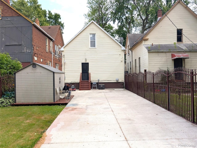 3639 Farnsworth St, Detroit, MI 48211 - rear view of property featuring entry steps and a storage shed