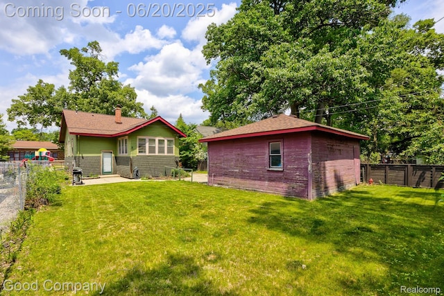 925 W Hazelhurst St, Ferndale, MI 48220 - back of property with a fenced backyard and a chimney