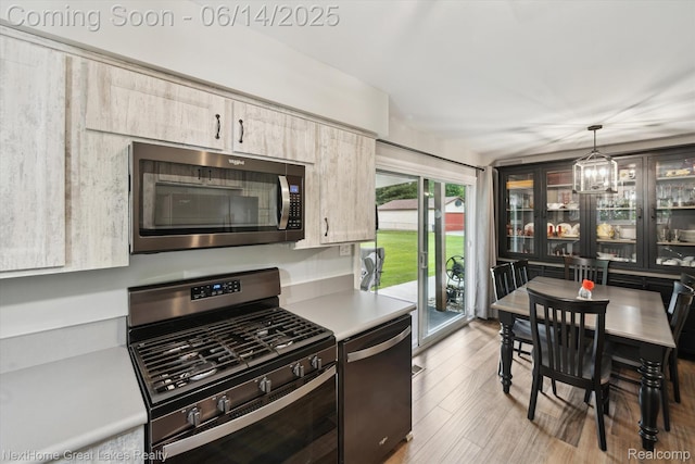 4098 Sam Snead Dr, Flint, MI 48506 - kitchen featuring stainless steel appliances, light countertops, a chandelier, hanging light fixtures, and wood finished floors