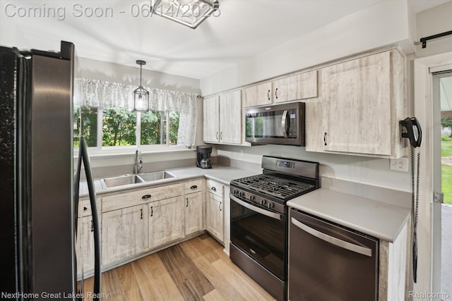 4098 Sam Snead Dr, Flint, MI 48506 - kitchen featuring stainless steel appliances, light wood-type flooring, light countertops, hanging light fixtures, and light brown cabinets