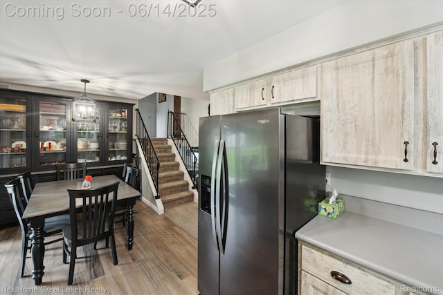 4098 Sam Snead Dr, Flint, MI 48506 - kitchen with stainless steel refrigerator with ice dispenser, wood finished floors, light brown cabinets, light countertops, and hanging light fixtures