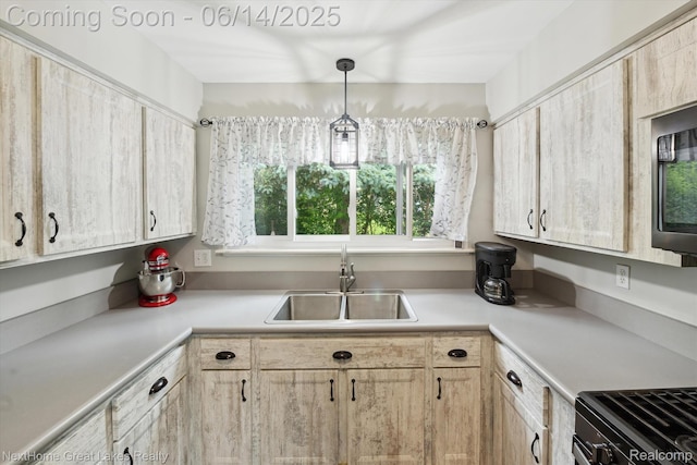 4098 Sam Snead Dr, Flint, MI 48506 - kitchen with light brown cabinetry, light countertops, and hanging light fixtures