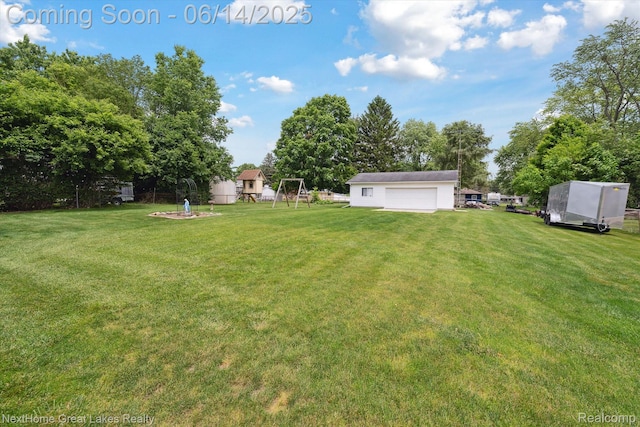 4098 Sam Snead Dr, Flint, MI 48506 - view of green lawn featuring a detached garage and an outdoor structure