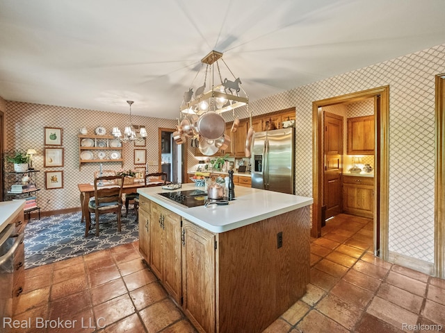 1299 Orchard Ridge Rd, Bloomfield Hills, MI 48304 - kitchen with stainless steel fridge, wallpapered walls, a chandelier, black electric stovetop, and a center island