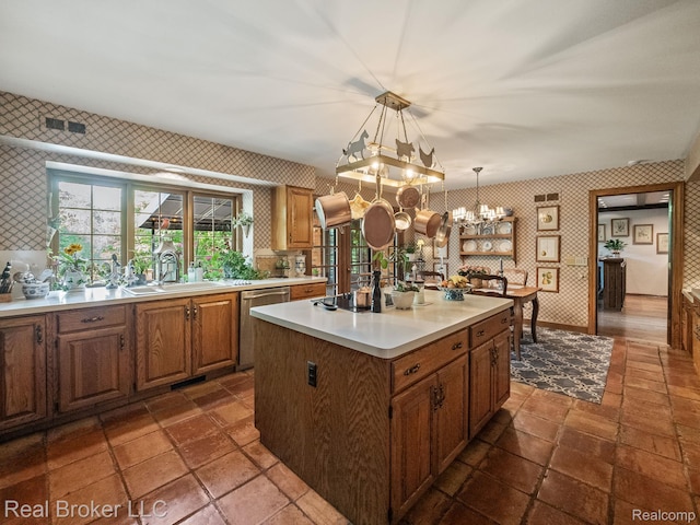 1299 Orchard Ridge Rd, Bloomfield Hills, MI 48304 - kitchen with wallpapered walls, dishwasher, a chandelier, light countertops, and decorative light fixtures