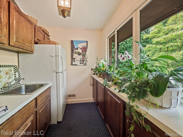 1299 Orchard Ridge Rd, Bloomfield Hills, MI 48304 - kitchen featuring light countertops, dark colored carpet, and brown cabinetry