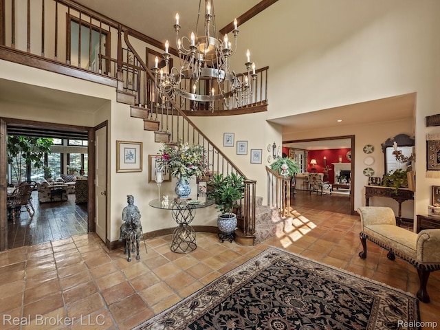 1299 Orchard Ridge Rd, Bloomfield Hills, MI 48304 - staircase featuring a high ceiling, tile patterned floors, and a chandelier