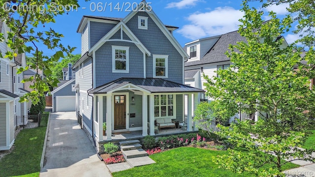 1060 Smith Ave, Birmingham, MI 48009 - view of front of property with a porch, a standing seam roof, a garage, a front yard, and a metal roof