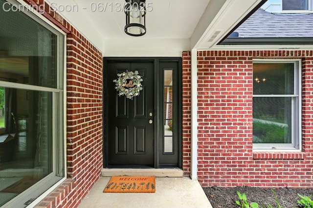 6535 Cedar Lake Rd, Pinckney, MI 48169 - view of exterior entry with brick siding and a porch