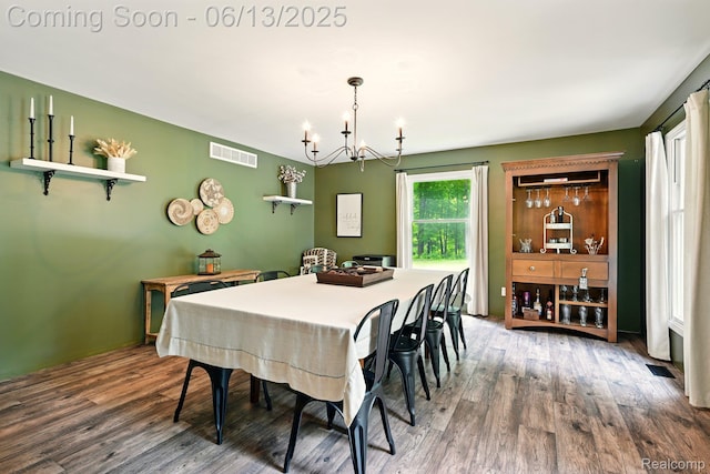 6535 Cedar Lake Rd, Pinckney, MI 48169 - dining area featuring a chandelier and wood finished floors