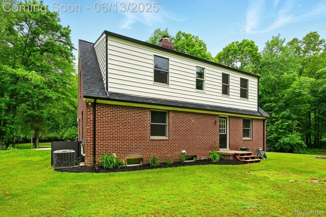 6535 Cedar Lake Rd, Pinckney, MI 48169 - rear view of house featuring a chimney, brick siding, and a yard