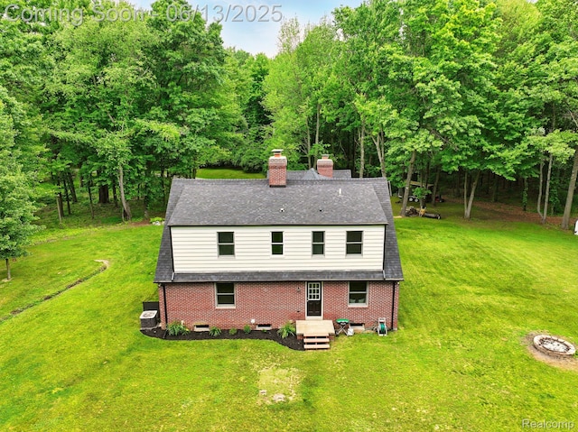 6535 Cedar Lake Rd, Pinckney, MI 48169 - back of house with a chimney, a yard, and brick siding