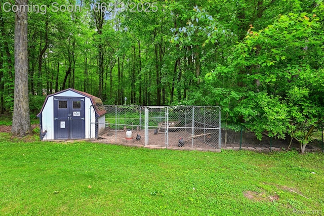 6535 Cedar Lake Rd, Pinckney, MI 48169 - view of grassy yard with exterior structure and a storage unit