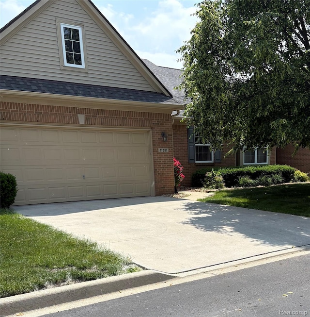 11081 Coventry Ct, Taylor, MI 48180 - view of front facade featuring brick siding, roof with shingles, and concrete driveway