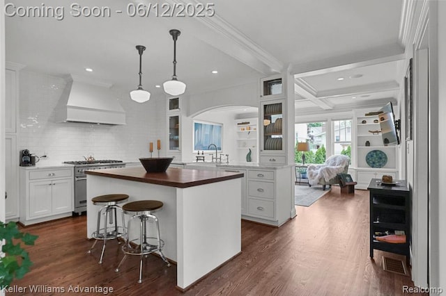1260 W Ann Arbor Trl, Plymouth, MI 48170 - kitchen with custom range hood, high end stainless steel range oven, butcher block countertops, glass insert cabinets, and dark wood finished floors