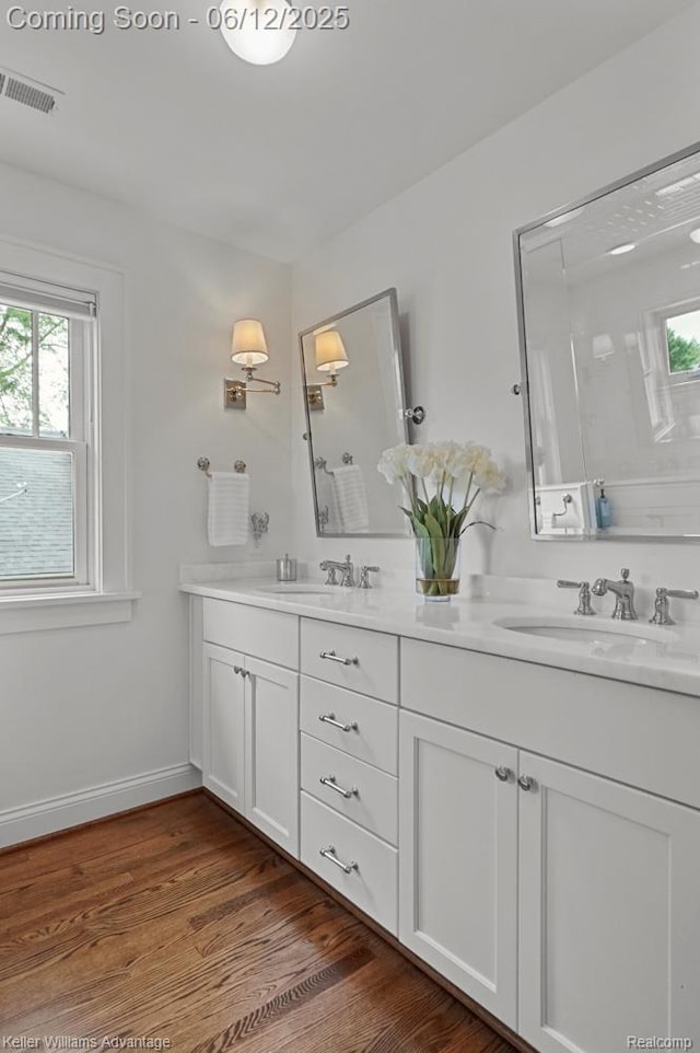 1260 W Ann Arbor Trl, Plymouth, MI 48170 - full bathroom with double vanity, healthy amount of natural light, and wood finished floors