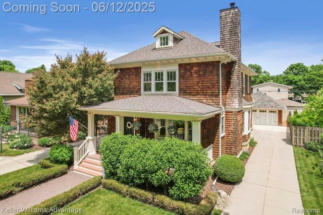 1260 W Ann Arbor Trl, Plymouth, MI 48170 - view of front facade featuring a chimney, roof with shingles, a garage, covered porch, and driveway