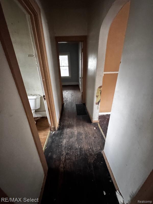 1108 Maginn Ct, Mount Morris, MI 48458 - corridor with arched walkways and wood finished floors
