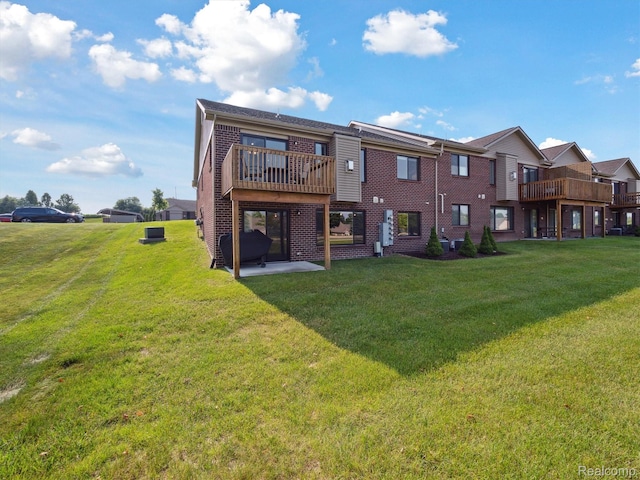 1470 Duncan Dr, Chelsea, MI 48118 - back of house with brick siding, a yard, and a deck