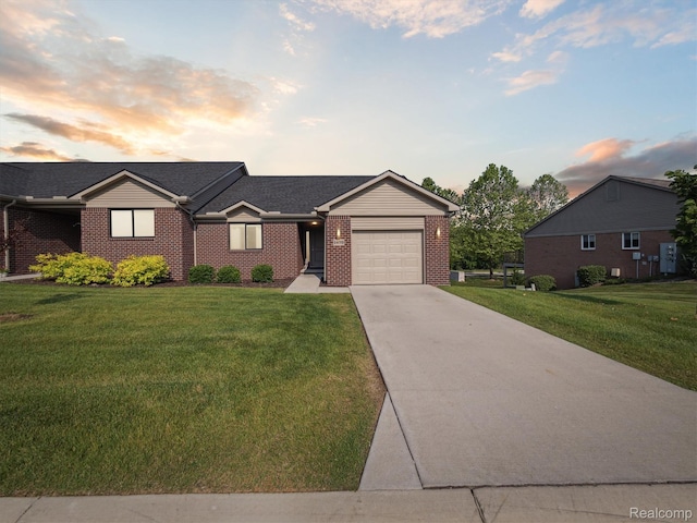 1470 Duncan Dr, Chelsea, MI 48118 - single story home with a garage, driveway, brick siding, and a front lawn